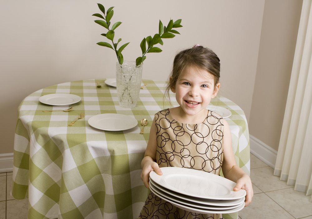child setting the table