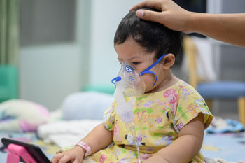 Baby hospitalized with RSV receives a breathing treatment.