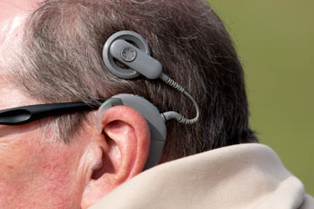 Older man with cochlear implant.