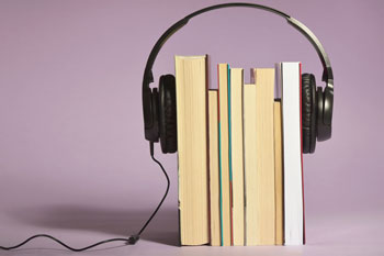 a set of headphones around several books