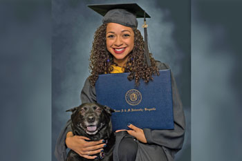 Graduation photo of Iris Freeman and her dog, Maya.