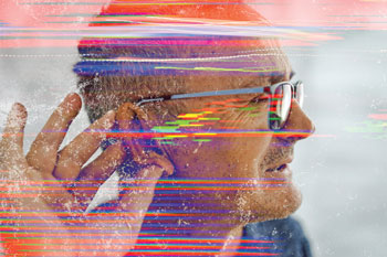 A man cups his ear with his fingers; superimposed colored lines indicate noise.